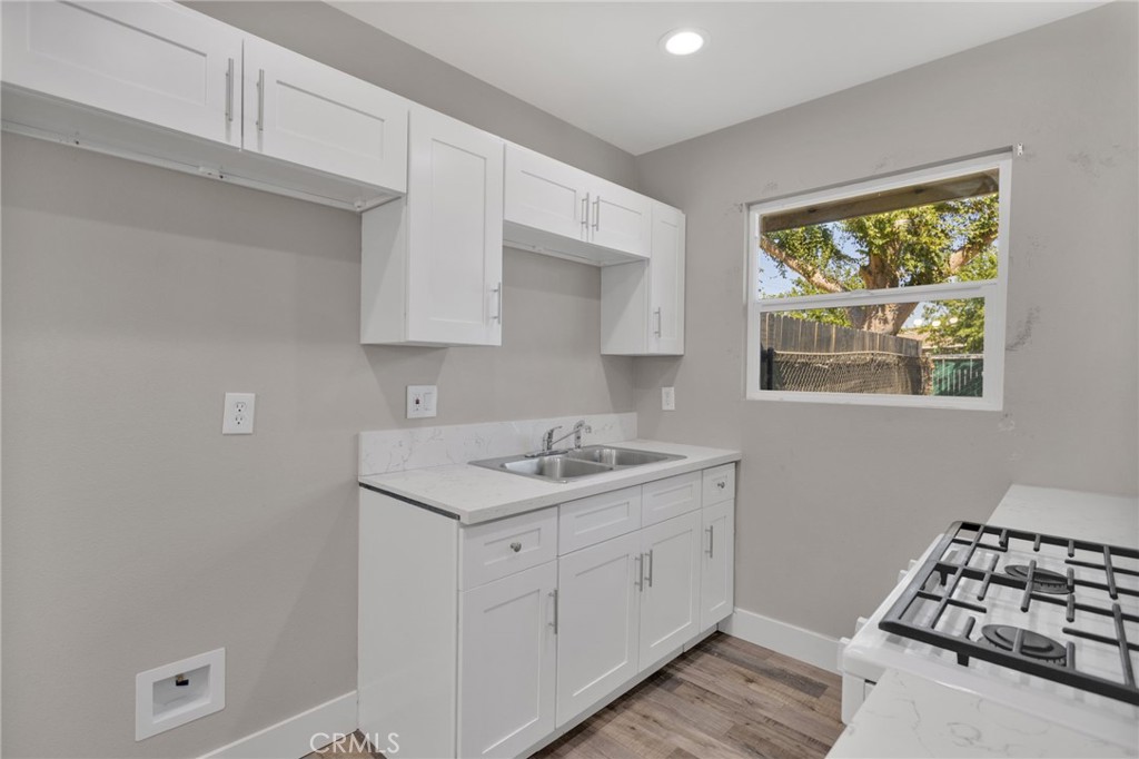 24521 Myers Avenue Moreno Valley, CA 92553 - Photo 2 of 9 a kitchen with a sink stove and cabinets