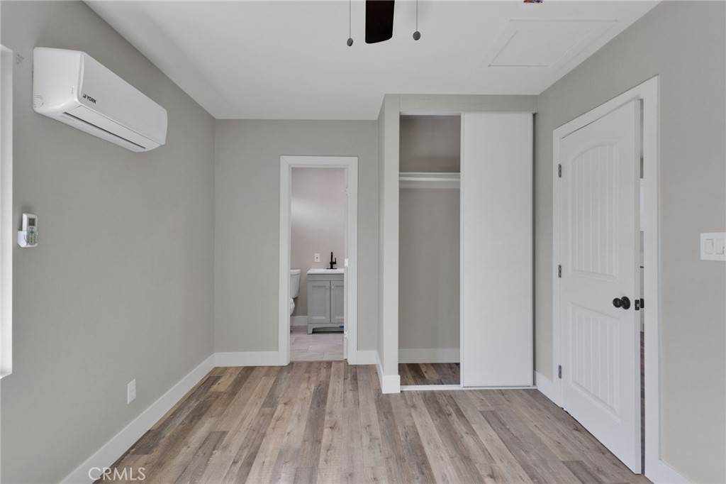 24521 Myers Avenue Moreno Valley, CA 92553 - Photo 4 of 9 a view of a room with wooden floor and a bathroom