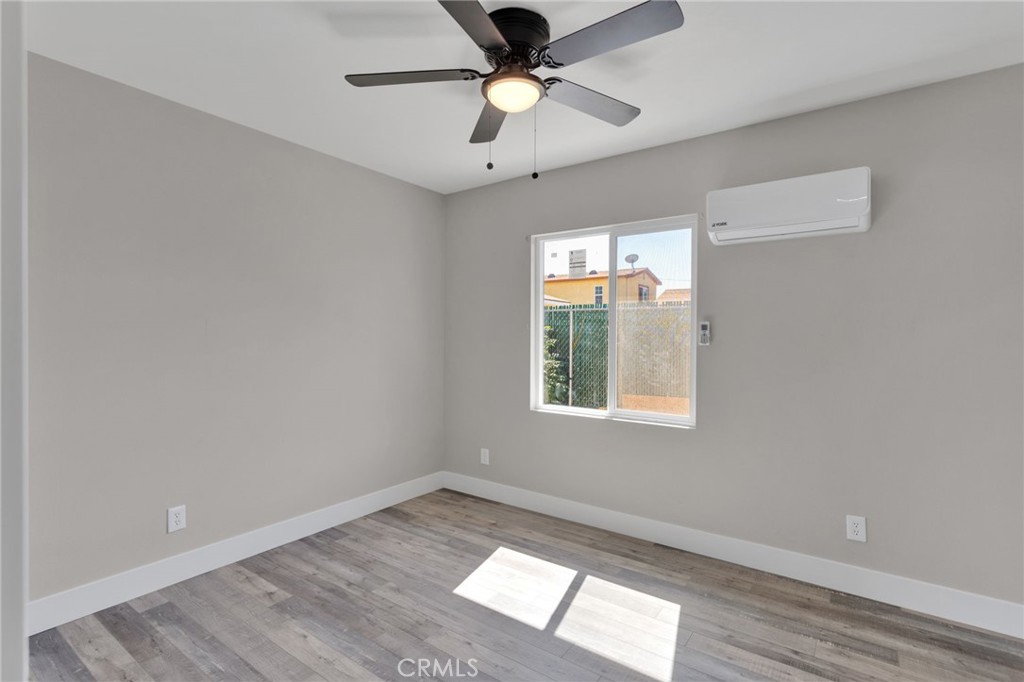 24521 Myers Avenue Moreno Valley, CA 92553 - Photo 7 of 9 a view of an empty room and window and chandelier fan