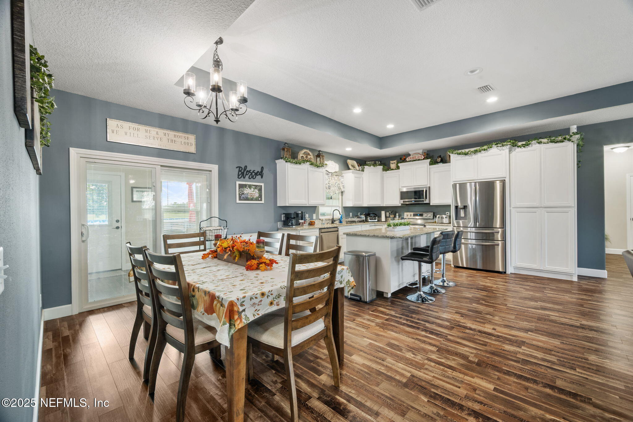 272344 Conner-Nelson Hilliard, FL 32046 - Photo 11 of 56 a view of a dining room with furniture and wooden floor