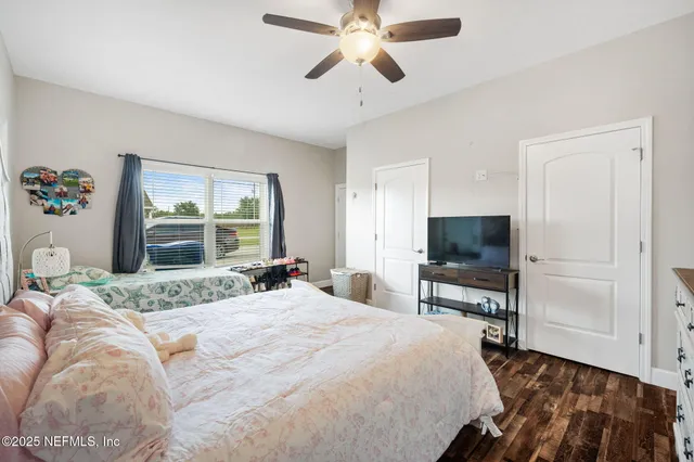 a bedroom with a large bed and a large window