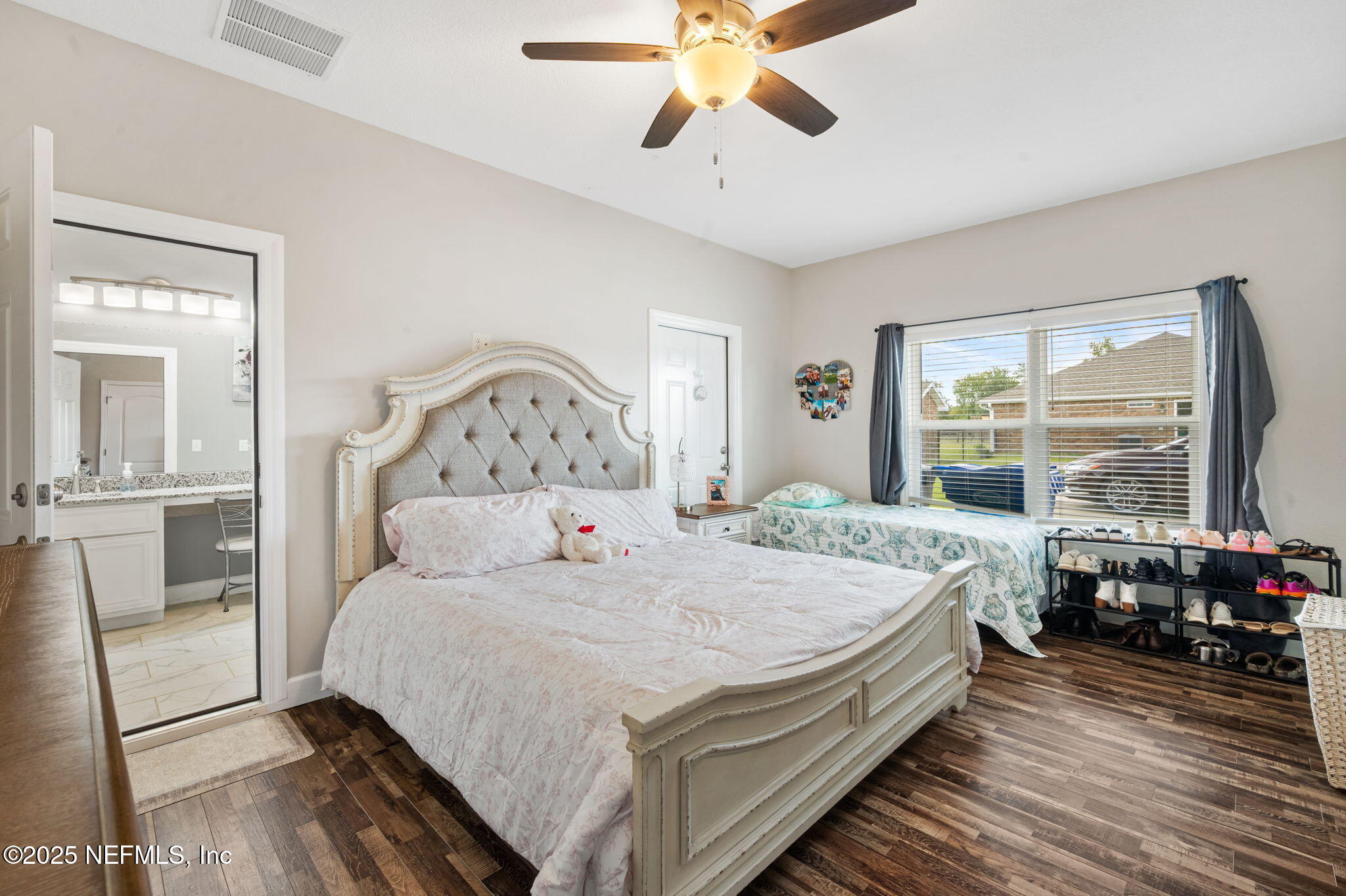 272344 Conner-Nelson Hilliard, FL 32046 - Photo 26 of 56 a bedroom with a large bed and a large window