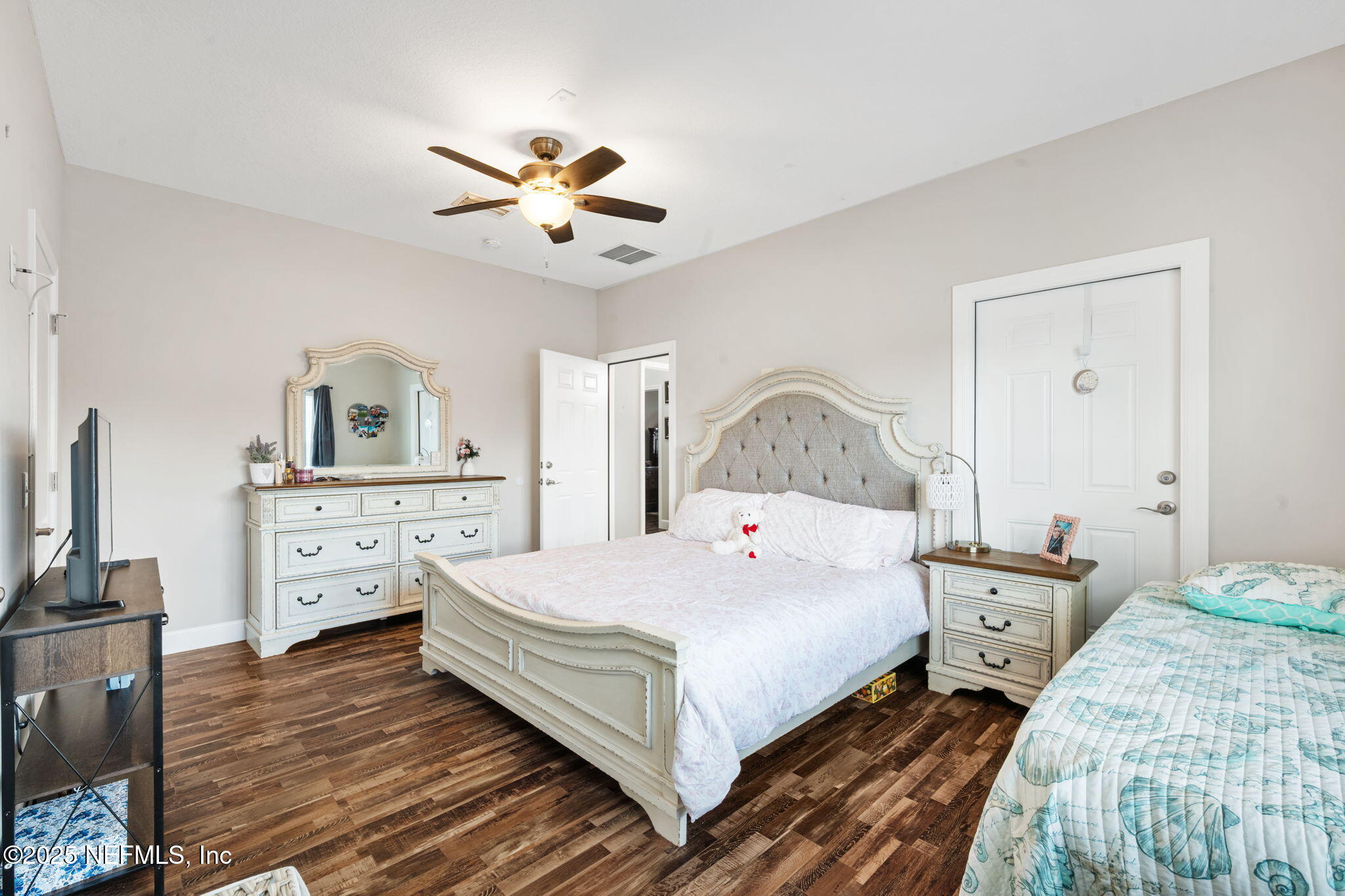 272344 Conner-Nelson Hilliard, FL 32046 - Photo 27 of 56 a bedroom with a bed and a chandelier