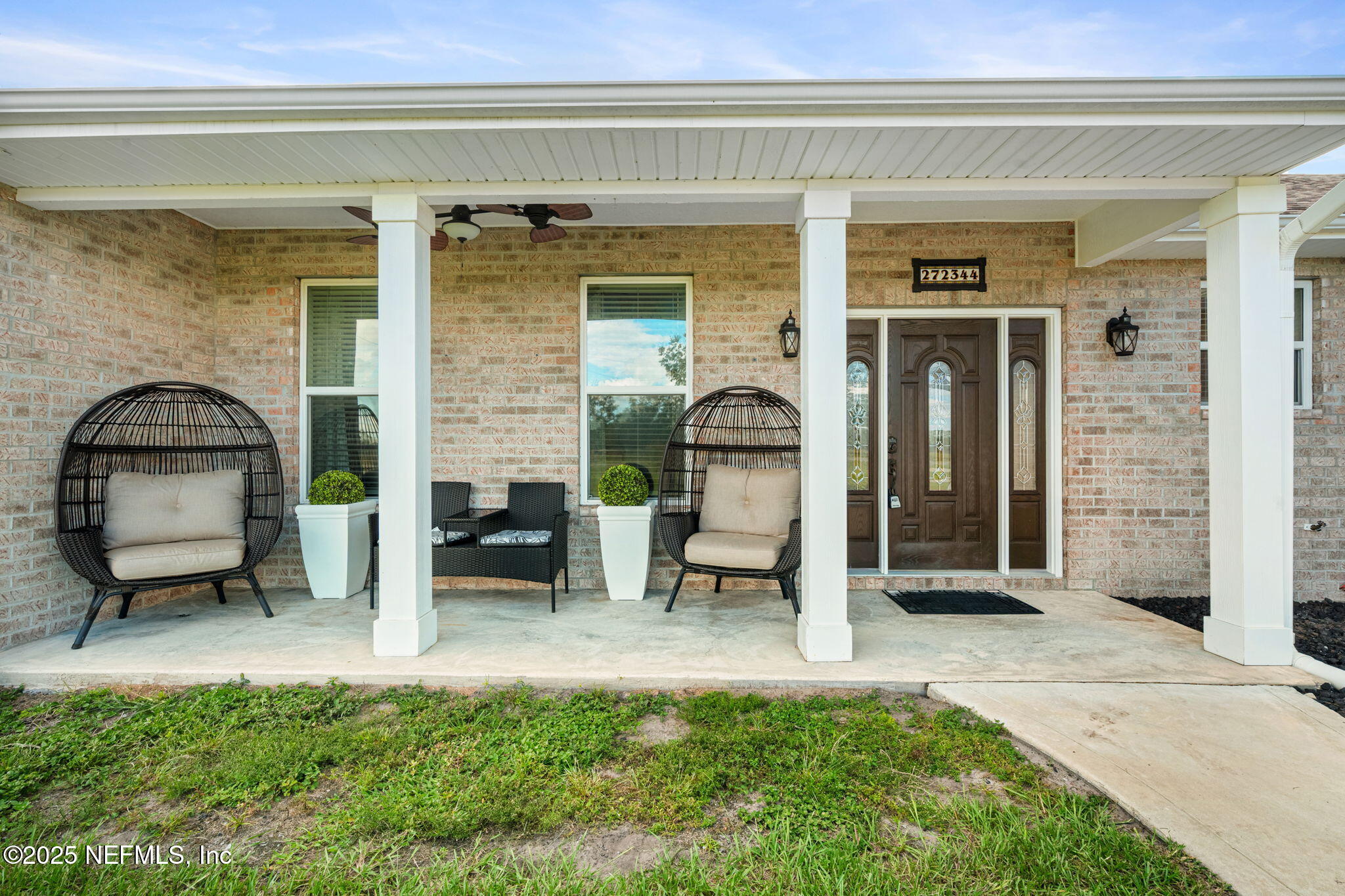 272344 Conner-Nelson Hilliard, FL 32046 - Photo 3 of 56 a view of a porch with a table and chairs