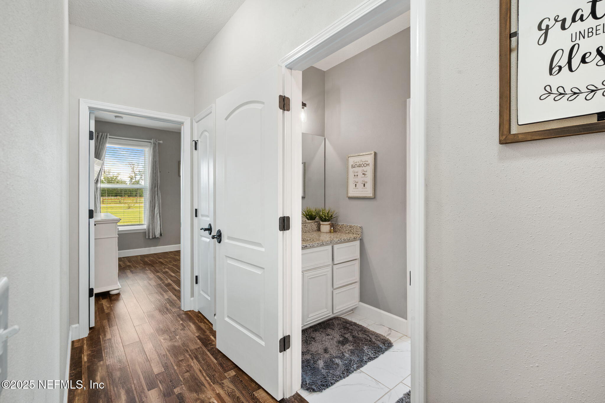 272344 Conner-Nelson Hilliard, FL 32046 - Photo 31 of 56 a view of a hallway with wooden floor and a living room