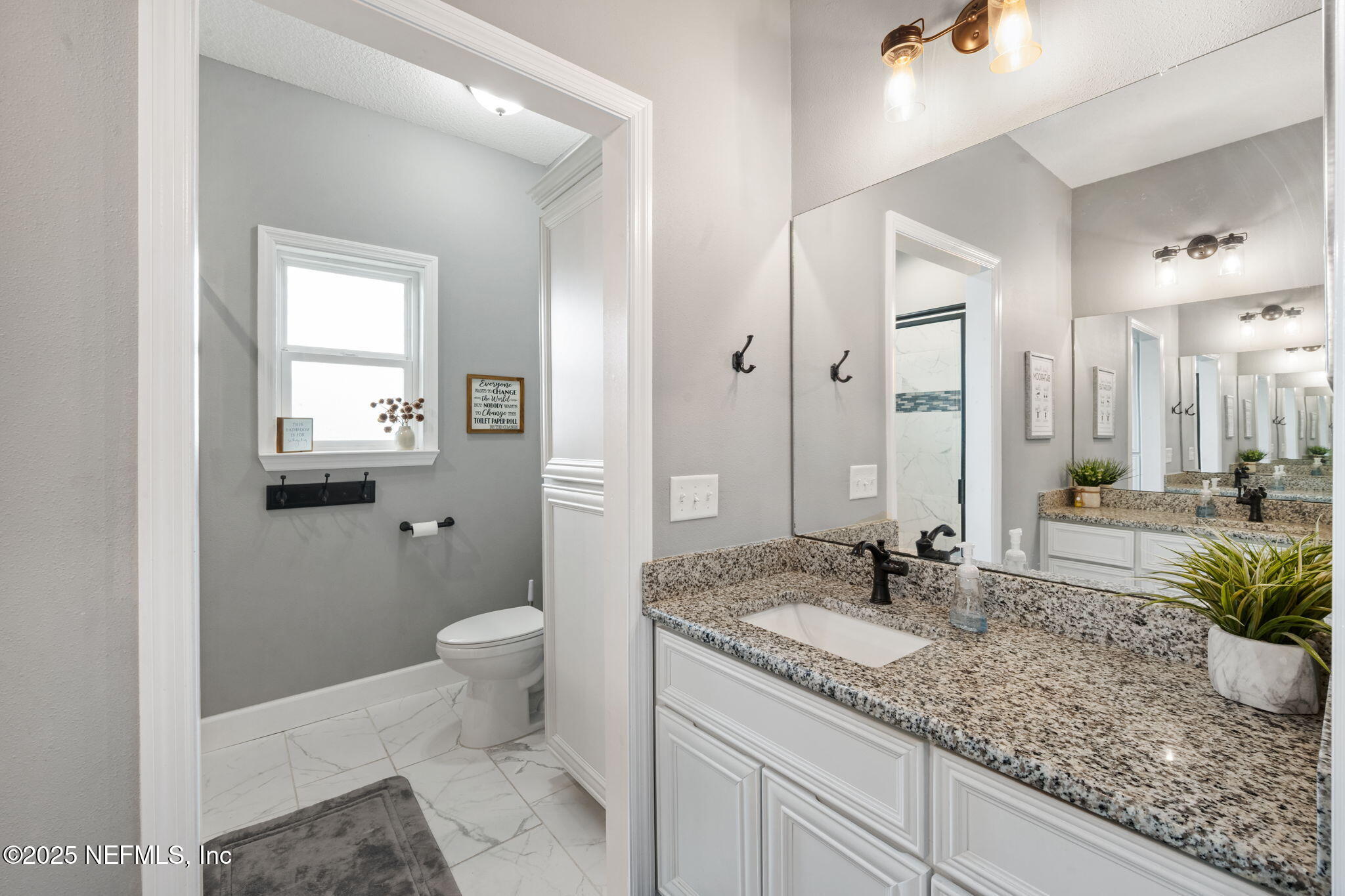 272344 Conner-Nelson Hilliard, FL 32046 - Photo 33 of 56 a bathroom with a granite countertop sink a toilet and mirror