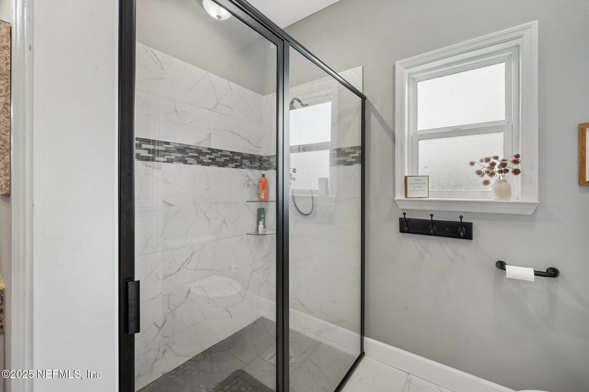 272344 Conner-Nelson Hilliard, FL 32046 - Photo 34 of 56 a bathroom with a glass shower door