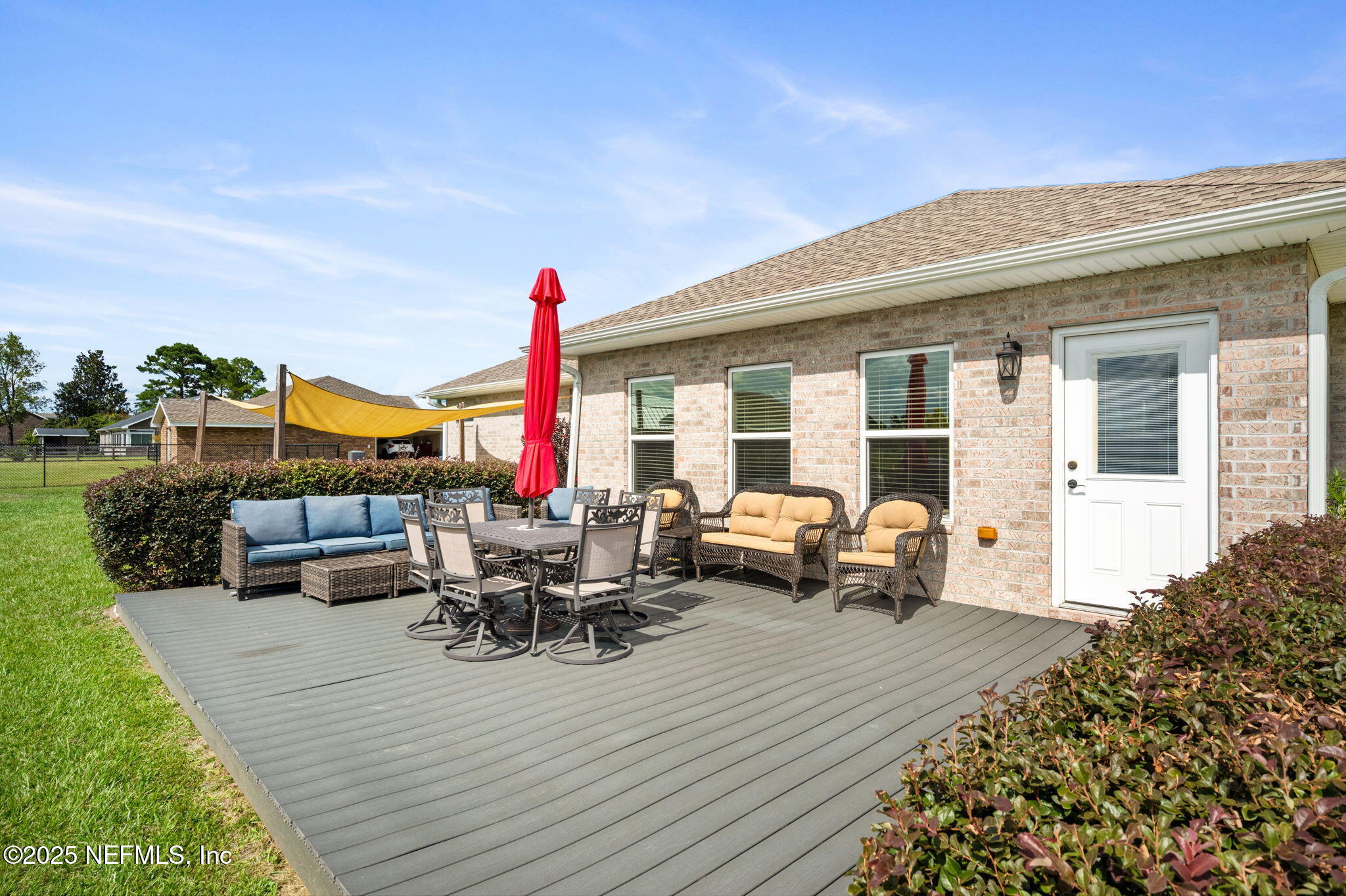 272344 Conner-Nelson Hilliard, FL 32046 - Photo 39 of 56 a view of a patio with couches and table and chairs with wooden floor and fence