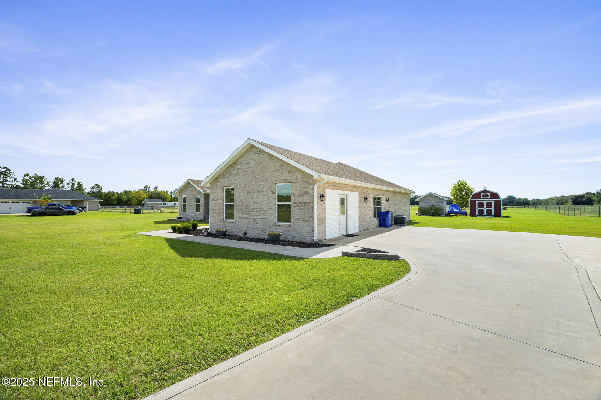272344 Conner-Nelson Hilliard, FL 32046 - Photo 48 of 56 a front view of house with yard and lake