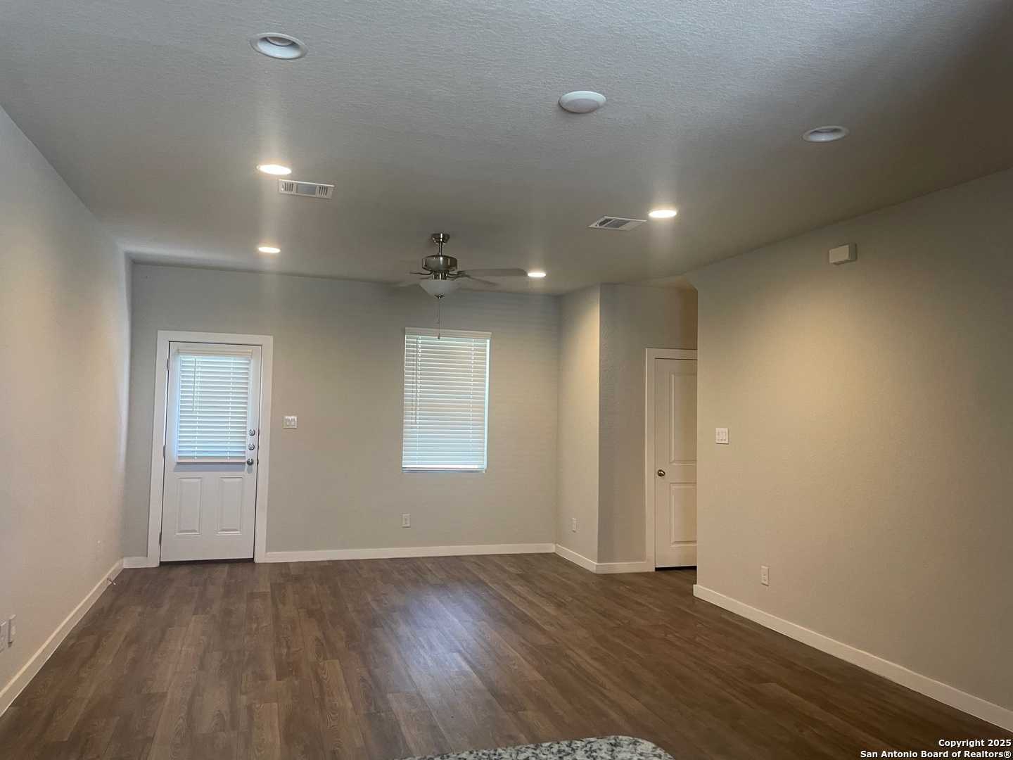 8318 Runner Cove, Unit 101 San Antonio, TX 78249 - Photo 18 of 36 an empty room with wooden floor and windows