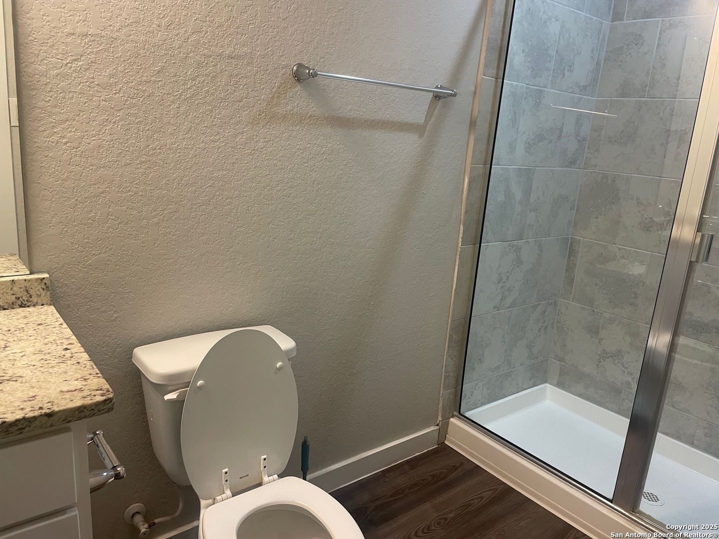 8318 Runner Cove, Unit 101 San Antonio, TX 78249 - Photo 22 of 36 a bathroom with a granite countertop sink toilet and shower