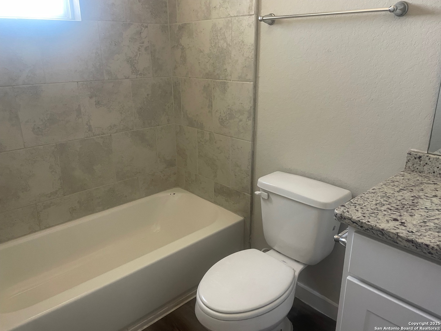 8318 Runner Cove, Unit 101 San Antonio, TX 78249 - Photo 24 of 36 a white toilet sitting next to a bath tub