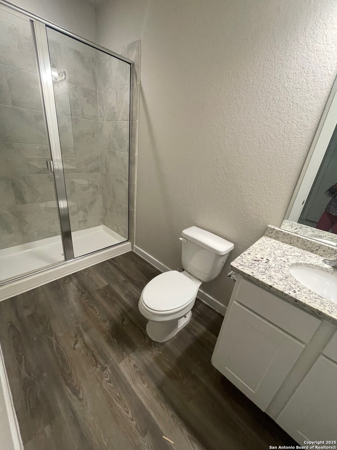 8318 Runner Cove, Unit 101 San Antonio, TX 78249 - Photo 26 of 36 a bathroom with a granite countertop sink toilet and shower