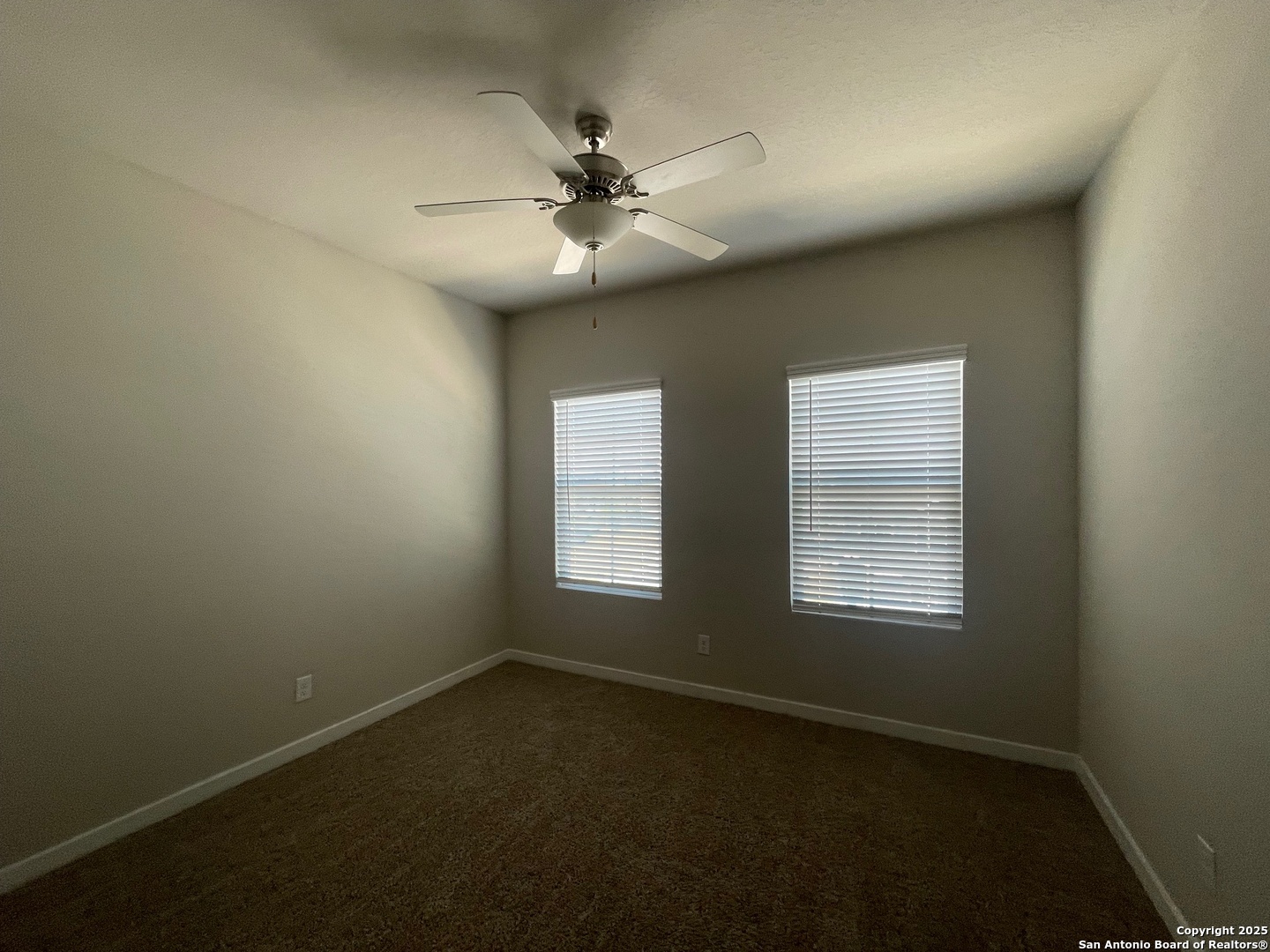 8318 Runner Cove, Unit 101 San Antonio, TX 78249 - Photo 30 of 36 an empty room with windows and fan
