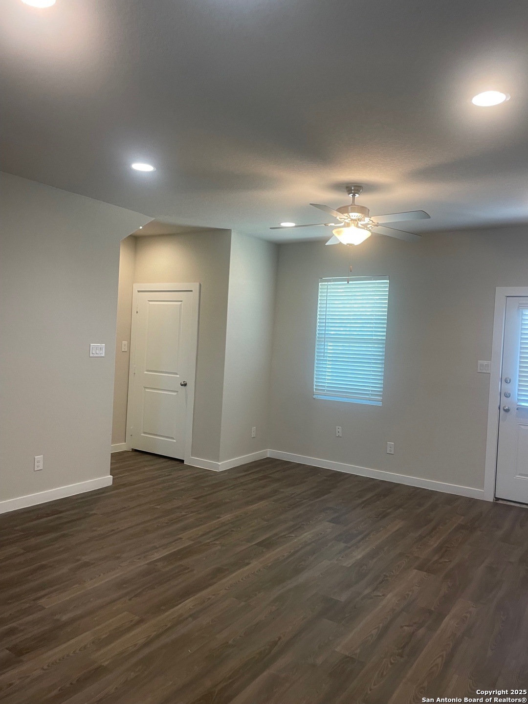 8318 Runner Cove, Unit 101 San Antonio, TX 78249 - Photo 31 of 36 an empty room with wooden floor and windows