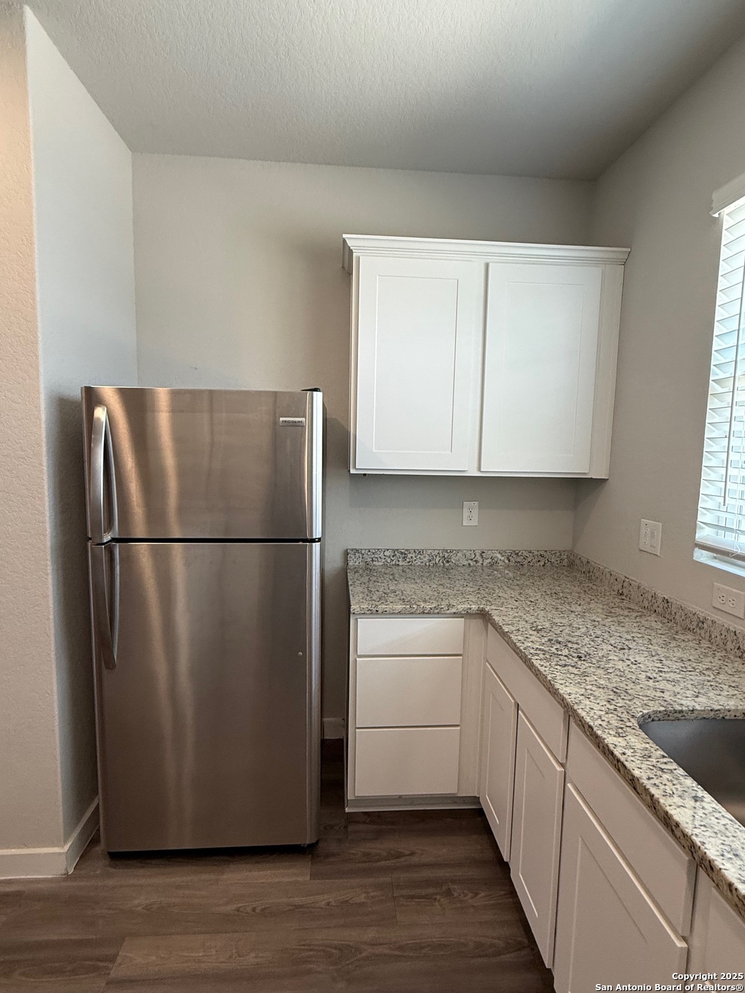 8318 Runner Cove, Unit 101 San Antonio, TX 78249 - Photo 6 of 36 a kitchen with a refrigerator sink and cabinets