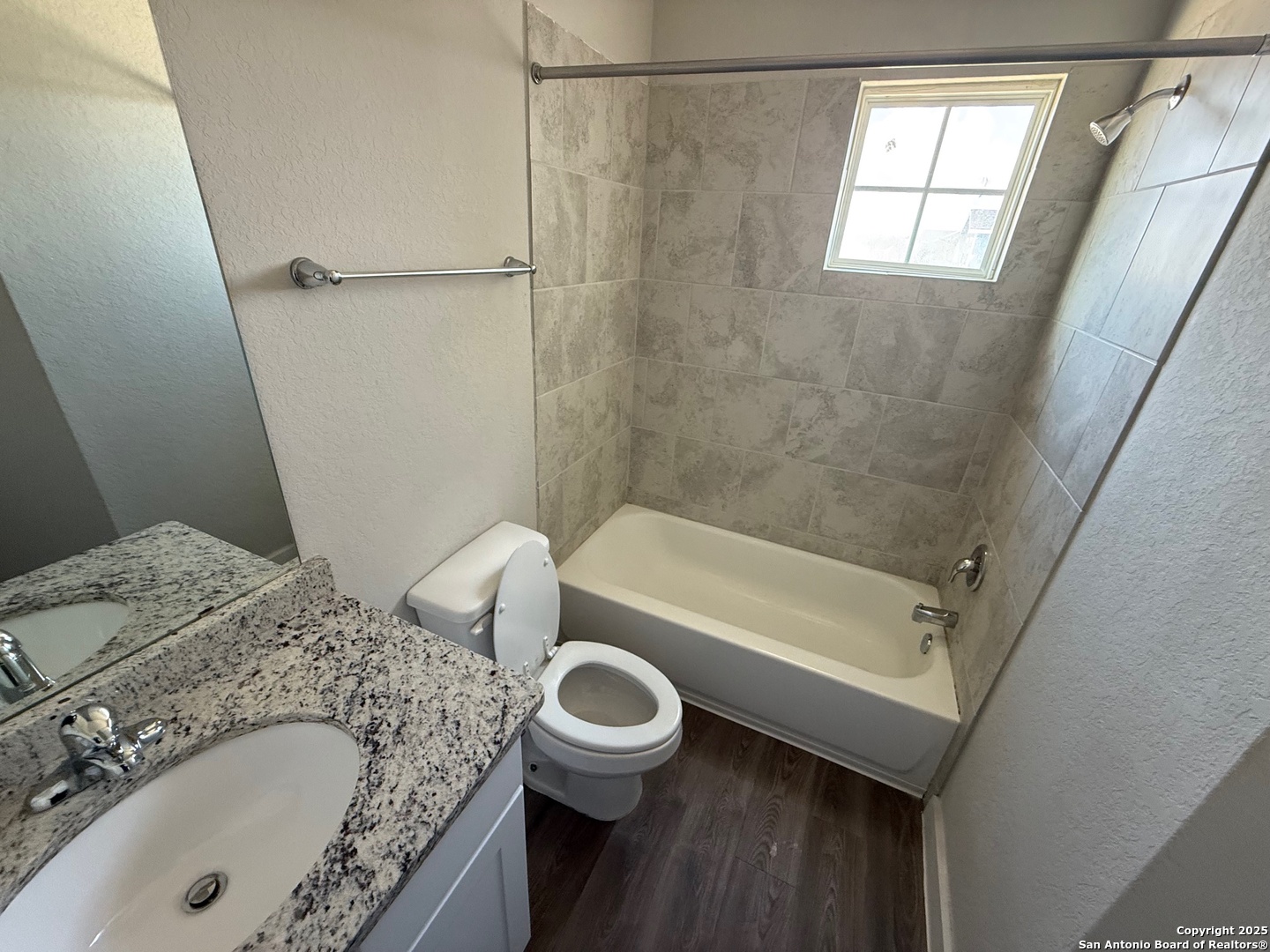 8318 Runner Cove, Unit 101 San Antonio, TX 78249 - Photo 7 of 36 a bathroom with a granite countertop sink a toilet and bathtub