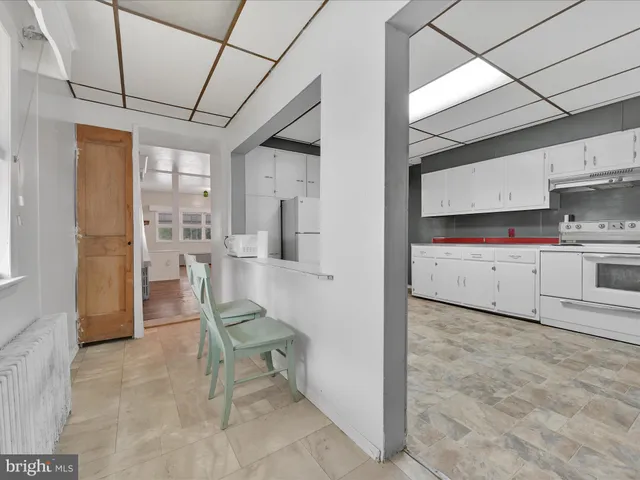 a living room with stainless steel appliances kitchen island granite countertop furniture and a kitchen view