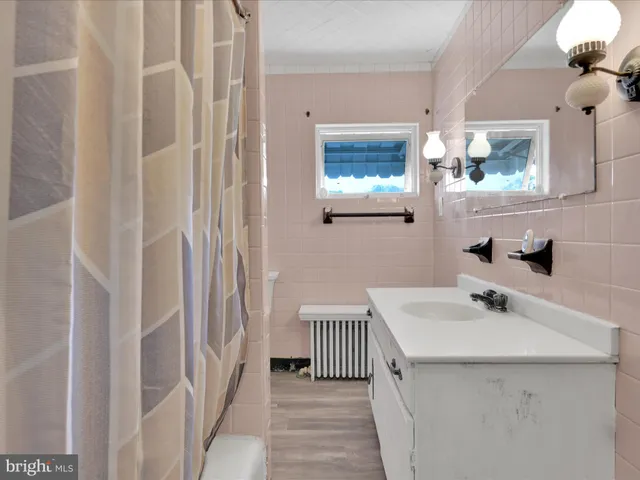 a bathroom with a sink a mirror and a shower