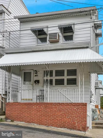 a view of a house with wooden fence