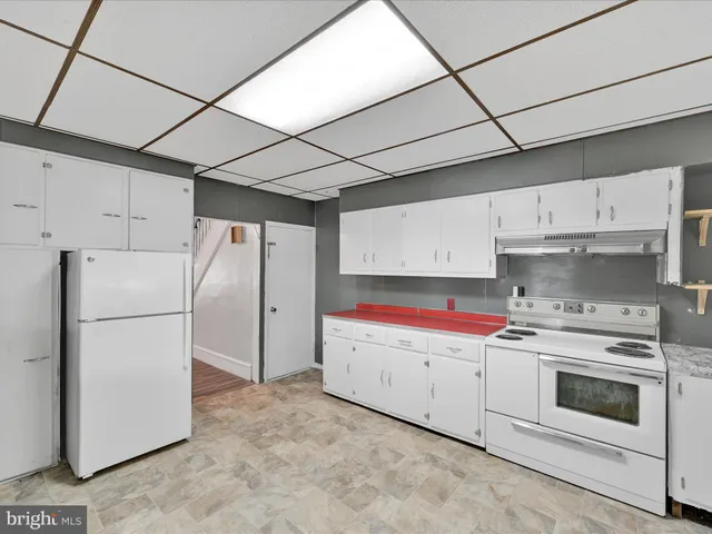 a kitchen with cabinets and white stainless steel appliances