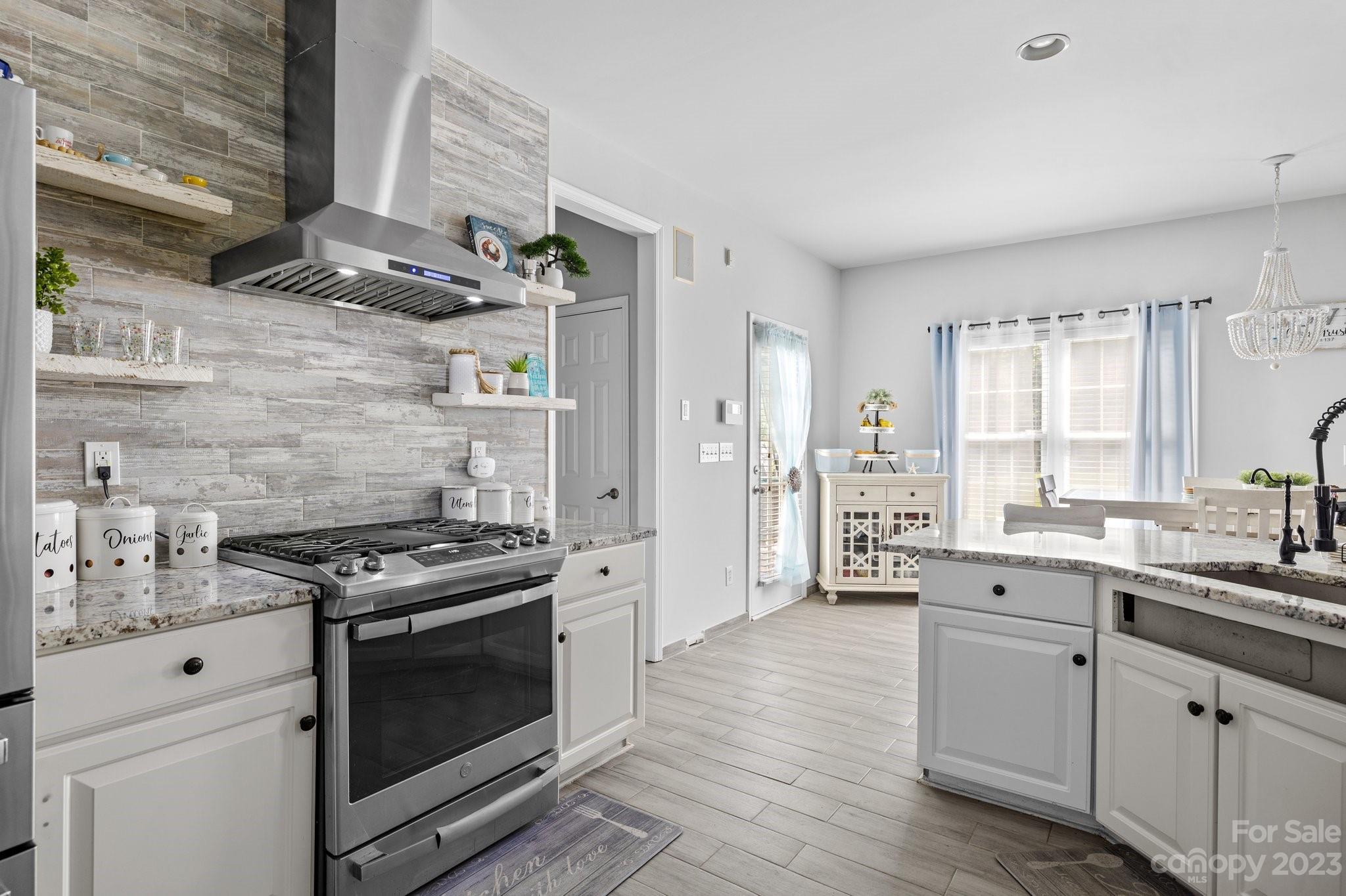 10834 Hellebore Road Charlotte, NC 28213 - Photo 12 of 41 a kitchen with stainless steel appliances a stove sink and refrigerator