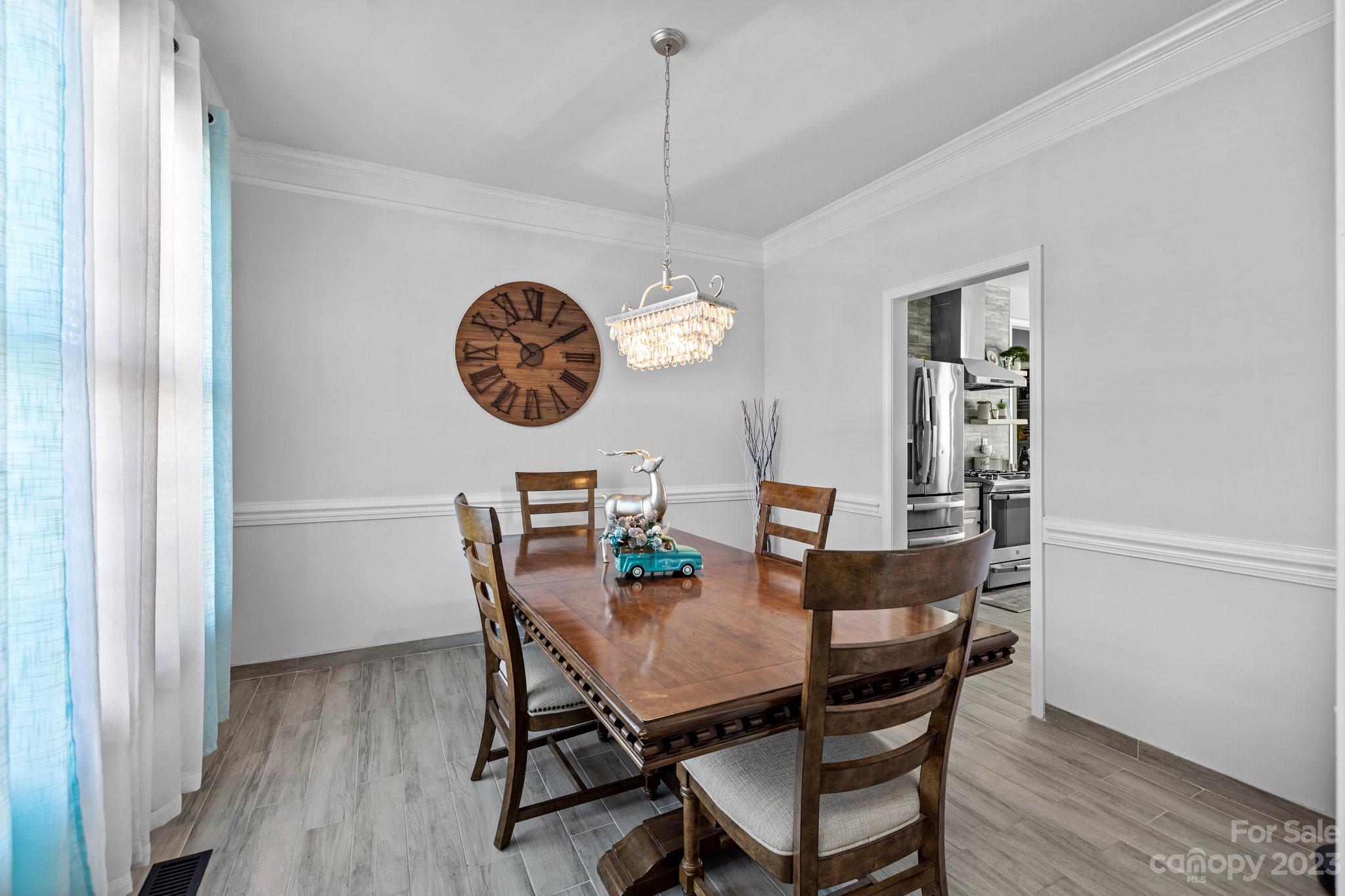 10834 Hellebore Road Charlotte, NC 28213 - Photo 15 of 41 a view of a dining room with furniture and wooden floor