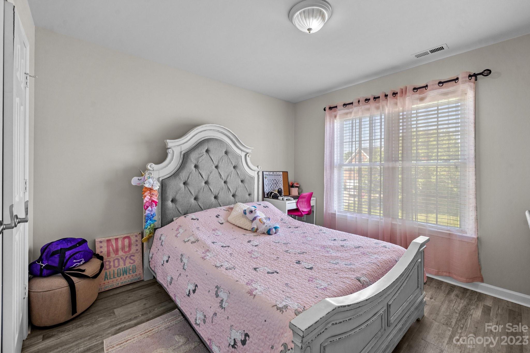 10834 Hellebore Road Charlotte, NC 28213 - Photo 16 of 41 a bed sitting in a bedroom next to a window