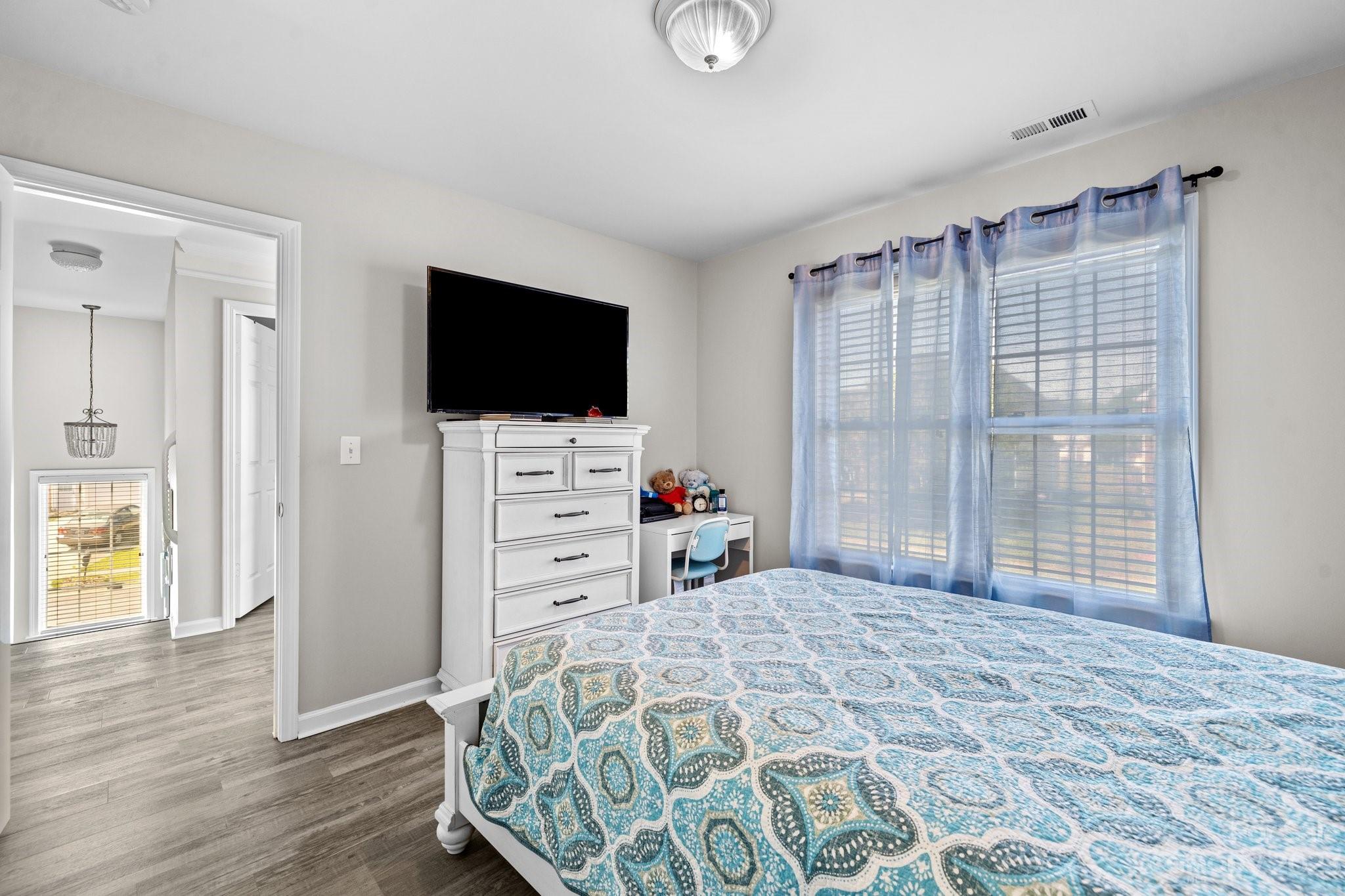 10834 Hellebore Road Charlotte, NC 28213 - Photo 19 of 41 a bedroom with a bed and a flat screen tv