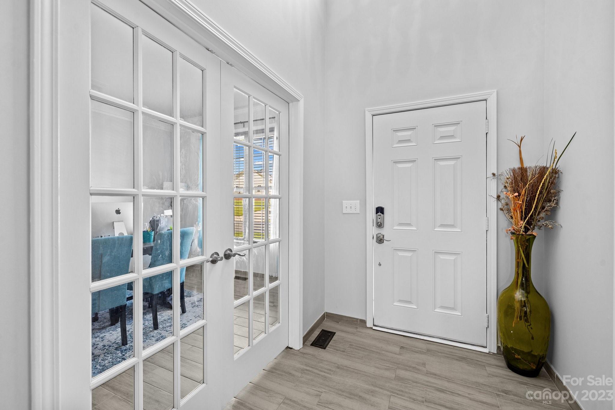 10834 Hellebore Road Charlotte, NC 28213 - Photo 2 of 41 a view of an entryway with wooden floor and door