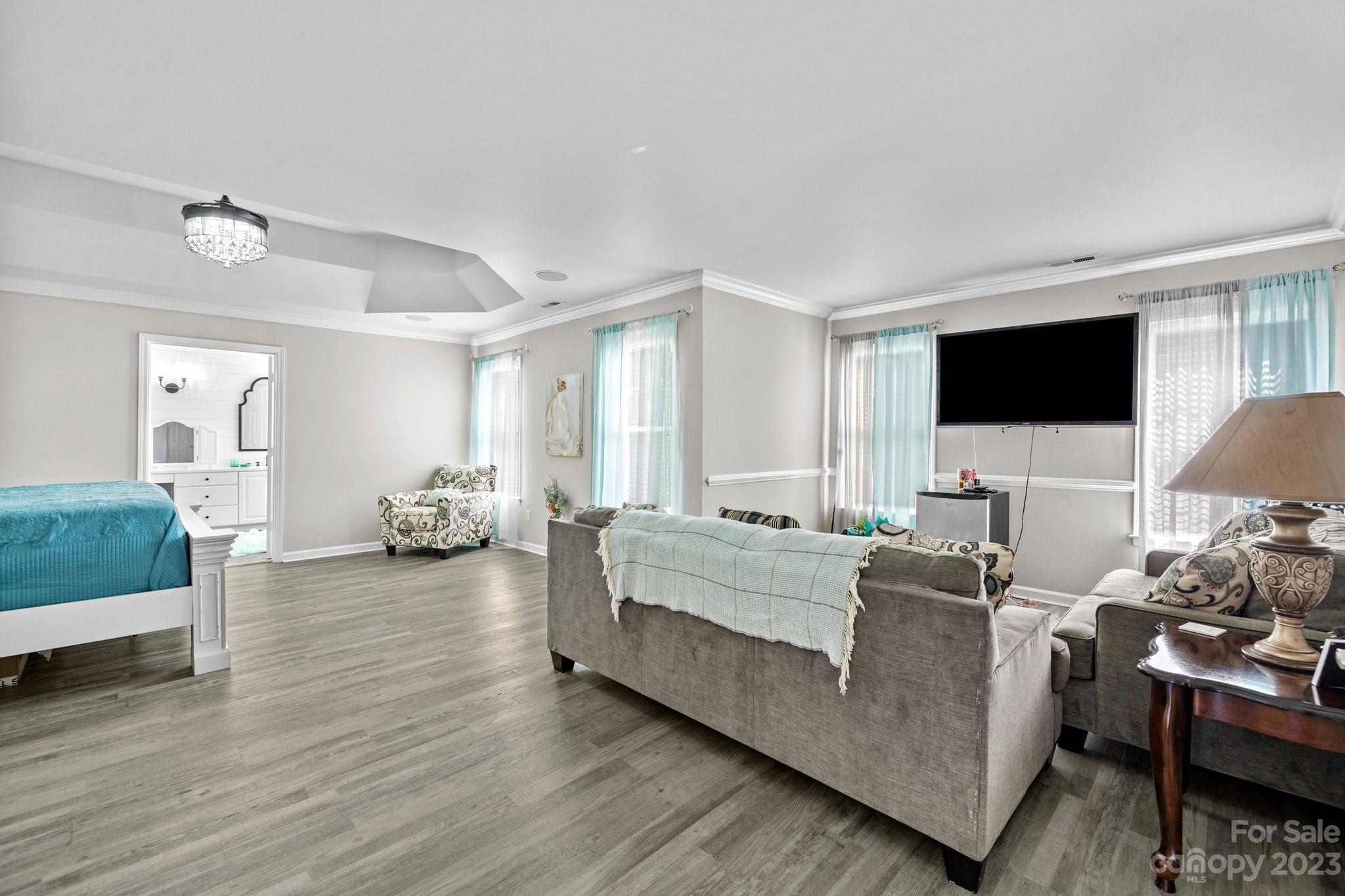 10834 Hellebore Road Charlotte, NC 28213 - Photo 23 of 41 a living room with furniture and a flat screen tv