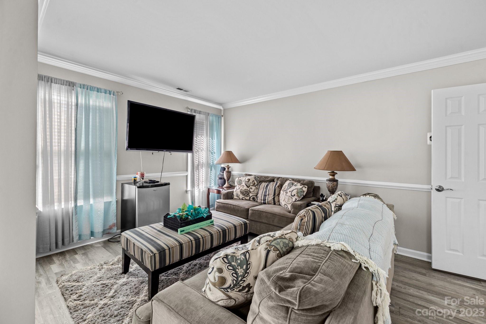 10834 Hellebore Road Charlotte, NC 28213 - Photo 24 of 41 a living room with furniture and a flat screen tv