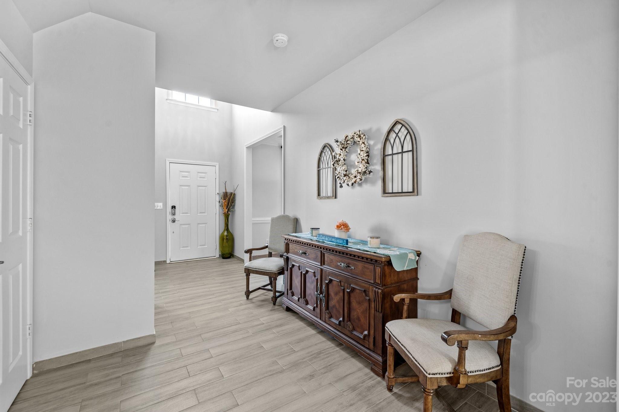 10834 Hellebore Road Charlotte, NC 28213 - Photo 3 of 41 a room with furniture and wooden floor
