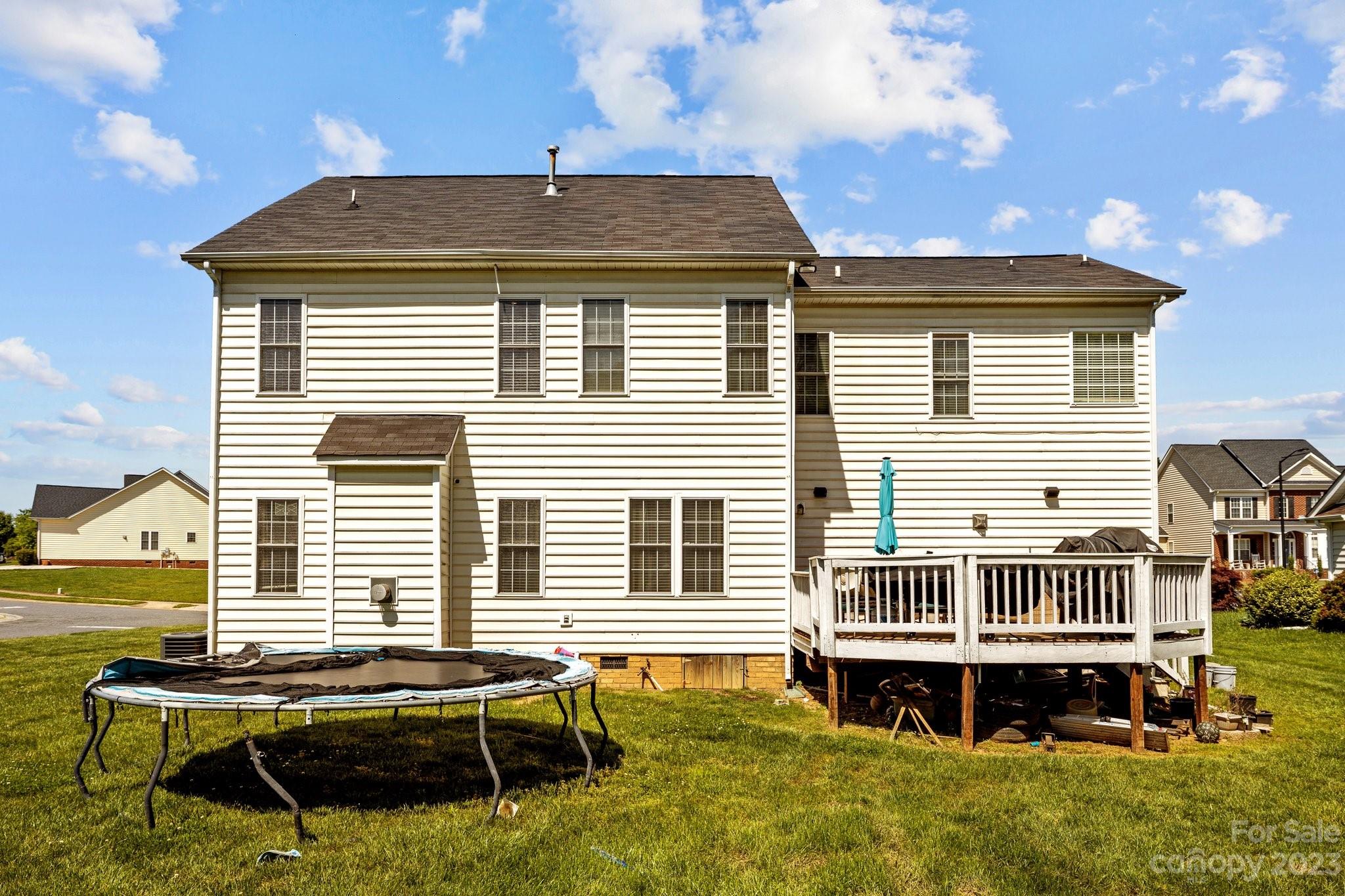 10834 Hellebore Road Charlotte, NC 28213 - Photo 34 of 41 a backyard of a house with wooden deck table and chairs