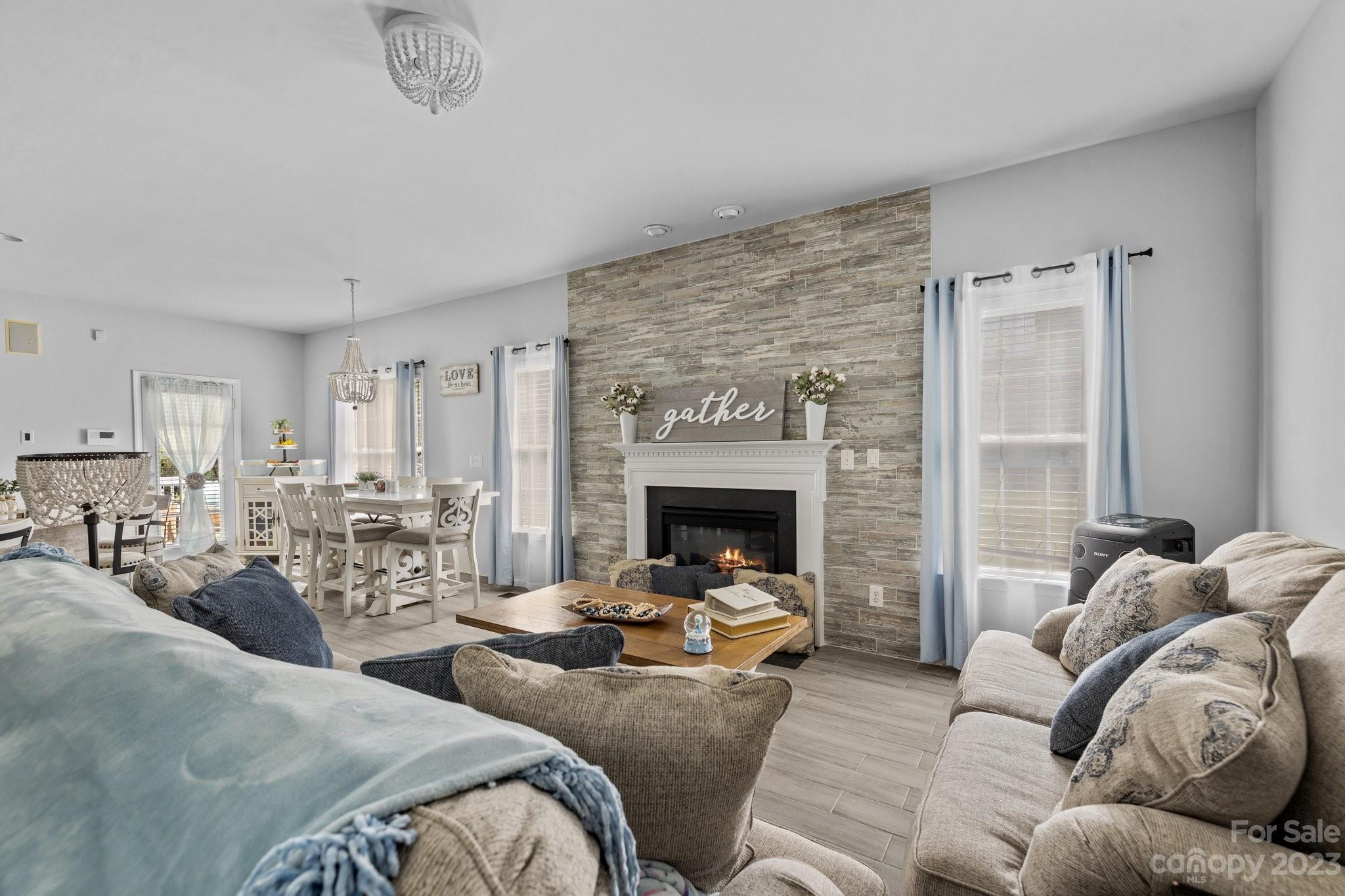 10834 Hellebore Road Charlotte, NC 28213 - Photo 4 of 41 a living room with furniture large window and a fireplace