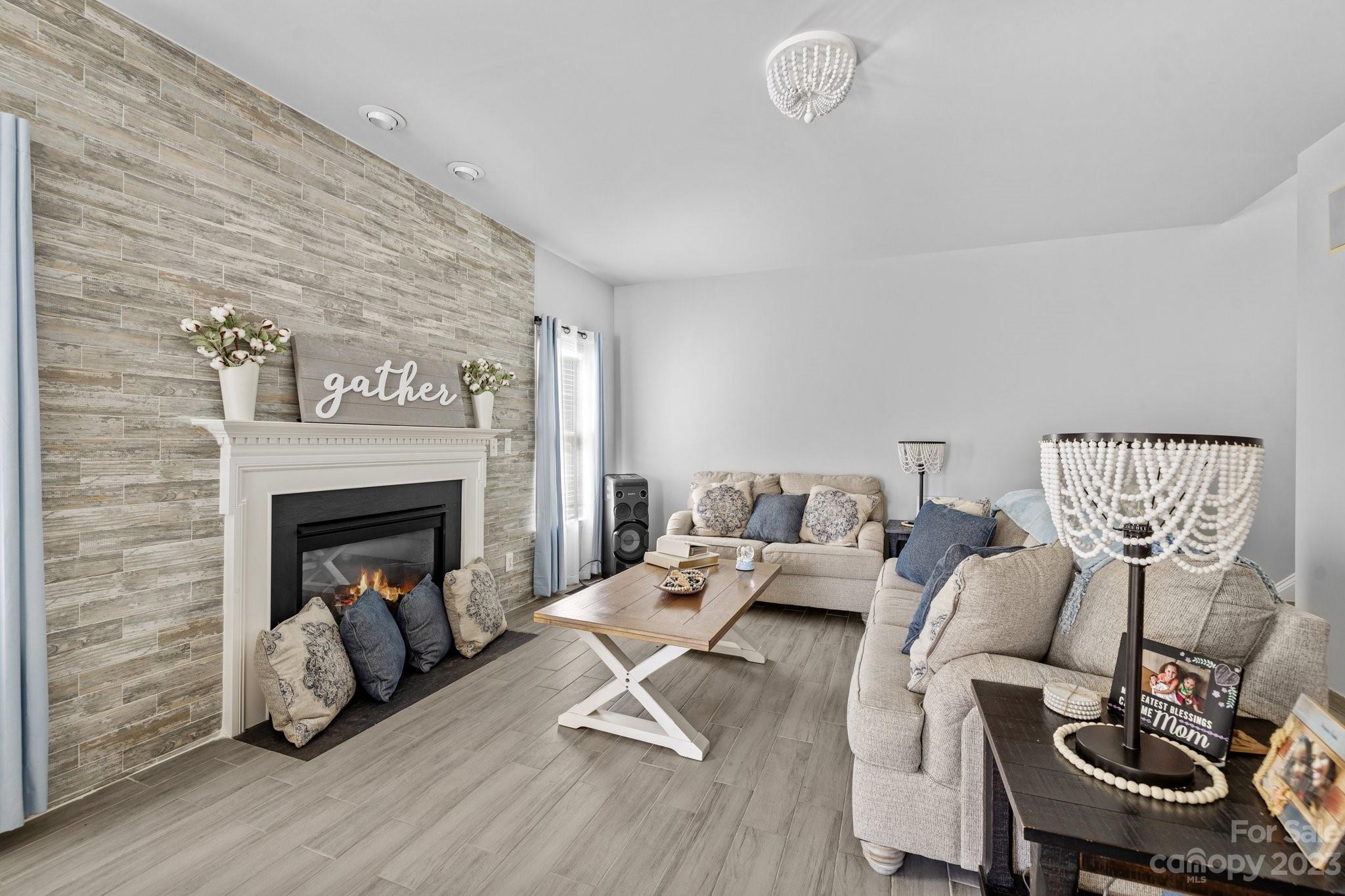 10834 Hellebore Road Charlotte, NC 28213 - Photo 7 of 41 a living room with furniture and a fireplace