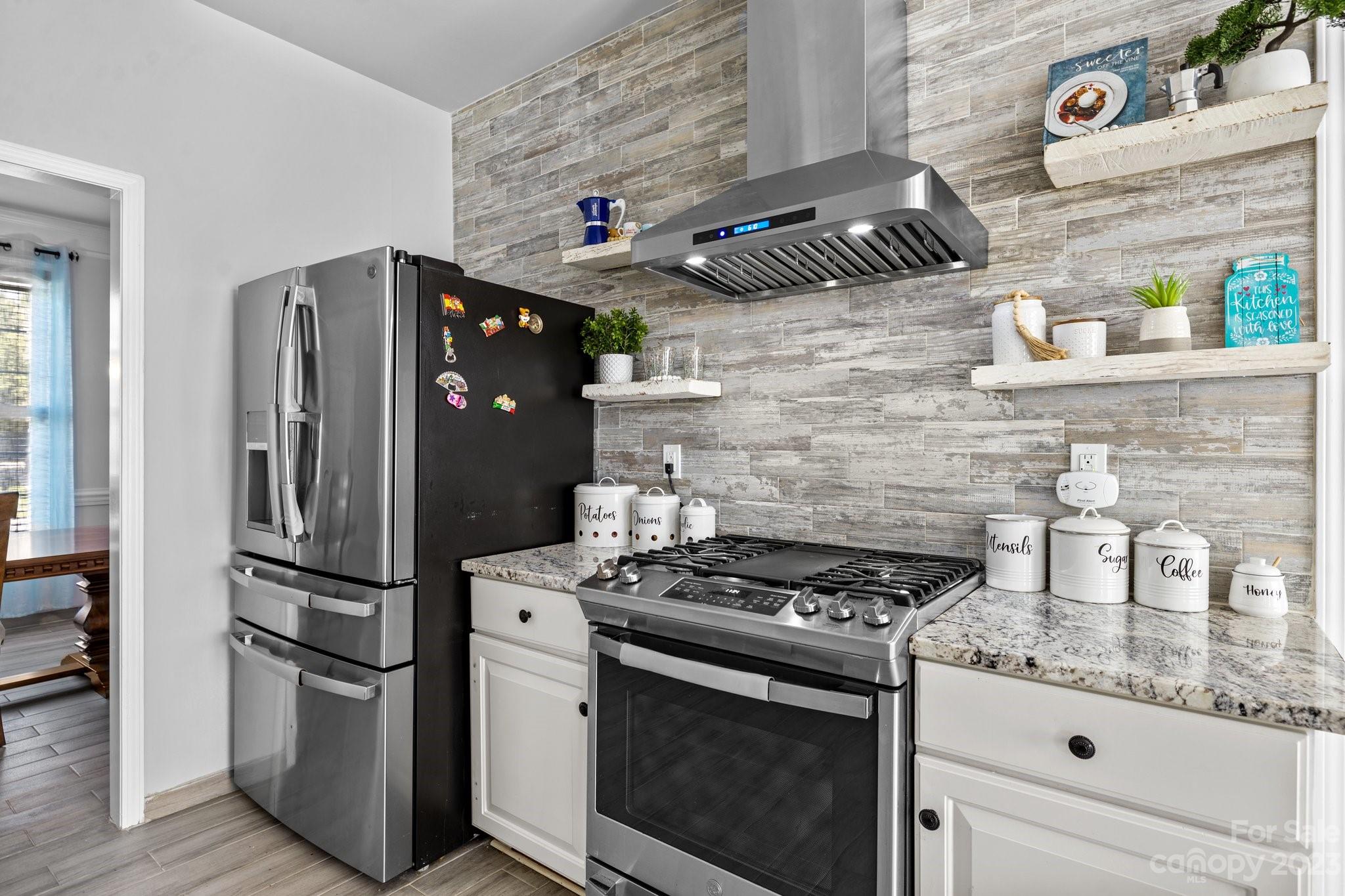 10834 Hellebore Road Charlotte, NC 28213 - Photo 9 of 41 a kitchen with stainless steel appliances granite countertop a stove and a refrigerator