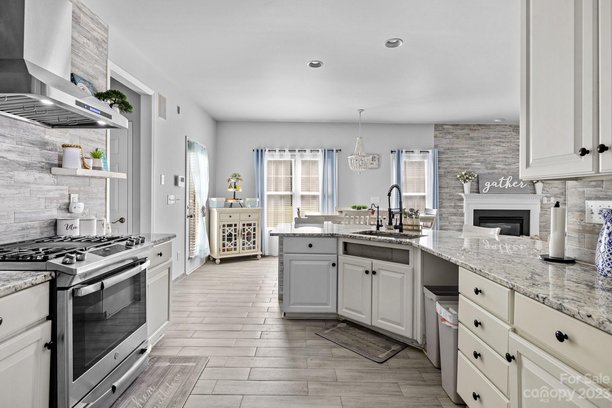 10834 Hellebore Road Charlotte, NC 28213 - Photo 10 of 41 a kitchen with granite countertop a sink stove and cabinets