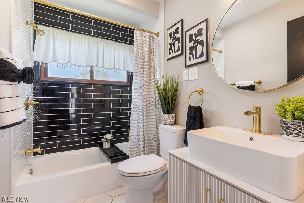 9620 David Road Garfield Heights, OH 44125 - Photo 15 of 36 Full bathroom featuring vanity, shower / bathtub combination with curtain, toilet, and tile flooring