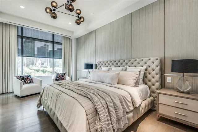 a bedroom with bed and large window