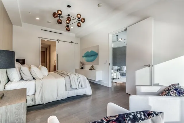 a spacious bedroom with a bed and couch