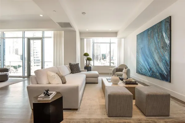 a living room with furniture and large windows