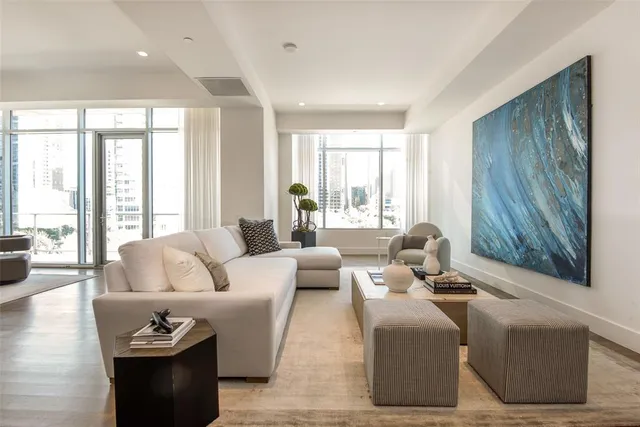 a living room with furniture and large windows