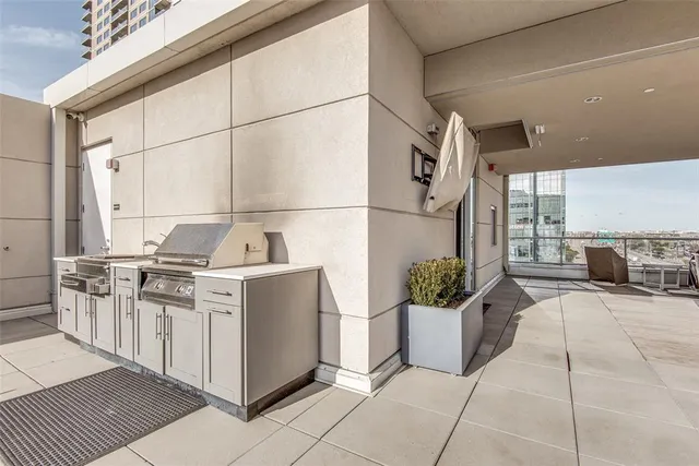 a kitchen with stainless steel appliances kitchen island granite countertop a refrigerator and a sink