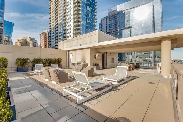 a view of the patio with couches and dining table with garden view