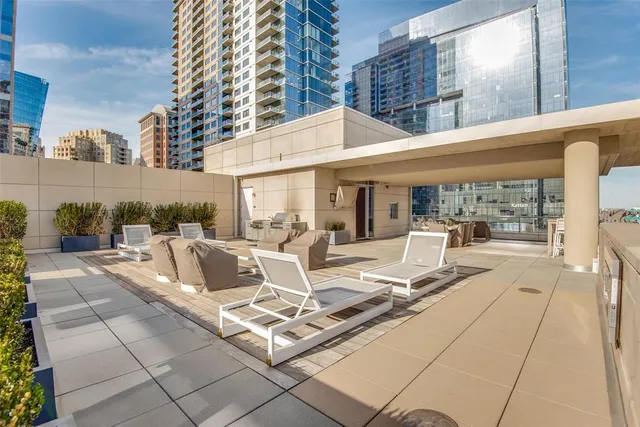 a view of the patio with couches and dining table with garden view