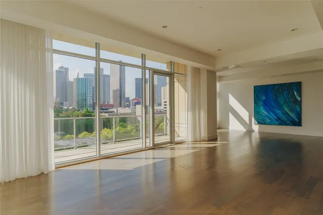 a view of an empty room with closet and a window