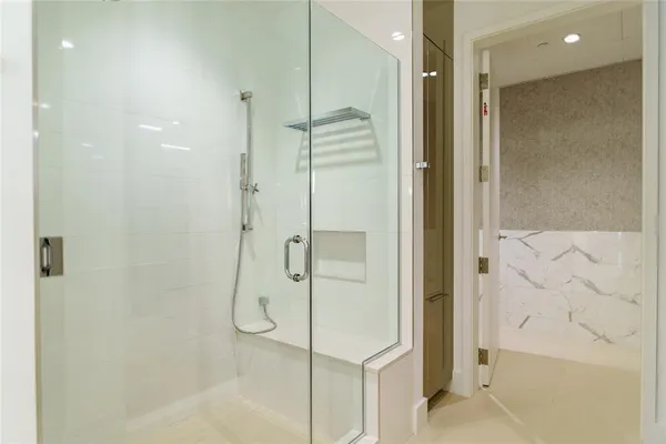 a bathroom with a tub sink double vanity and mirror