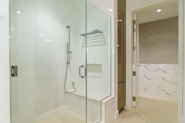 a bathroom with a tub sink double vanity and mirror