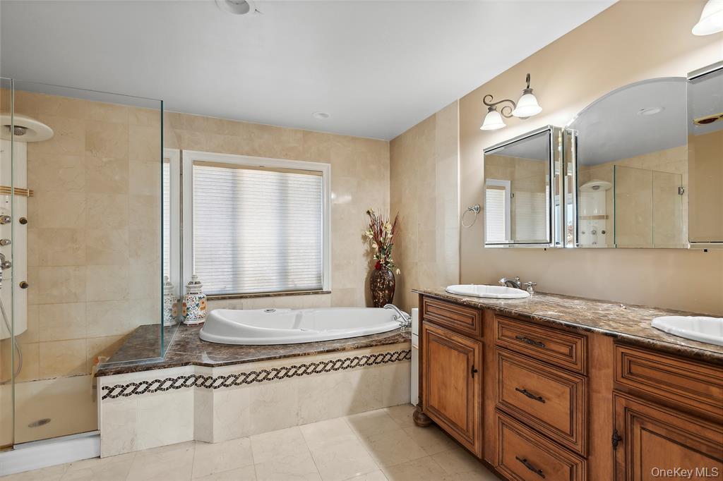 4 Quebec Road Island Park, NY 11558 - Photo 14 of 24 a spacious bathroom with a granite countertop sink and a mirror